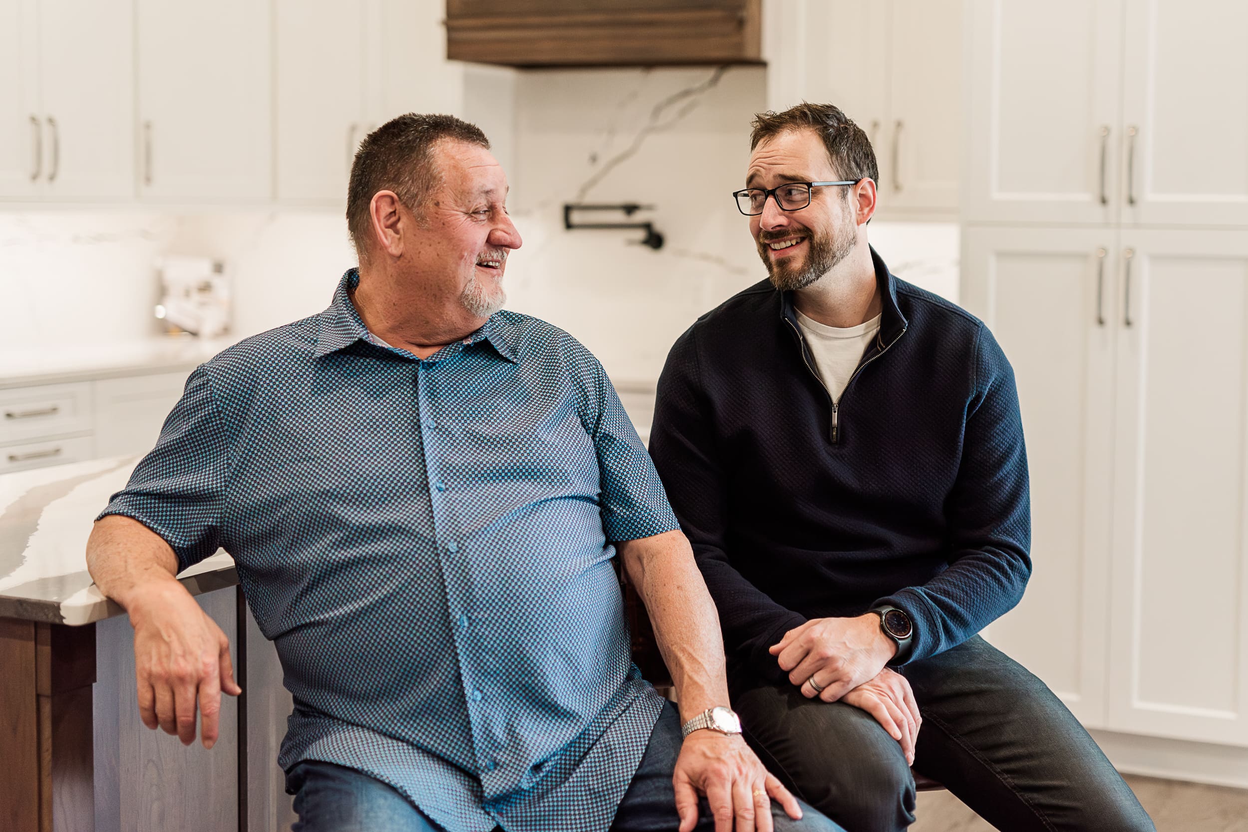 Father and son enjoying some humour during custom cabinetry photography session